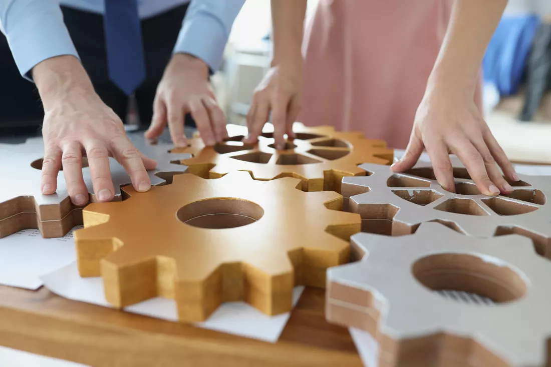 businesspeople-put-wooden-gears-workplace-together-work-team