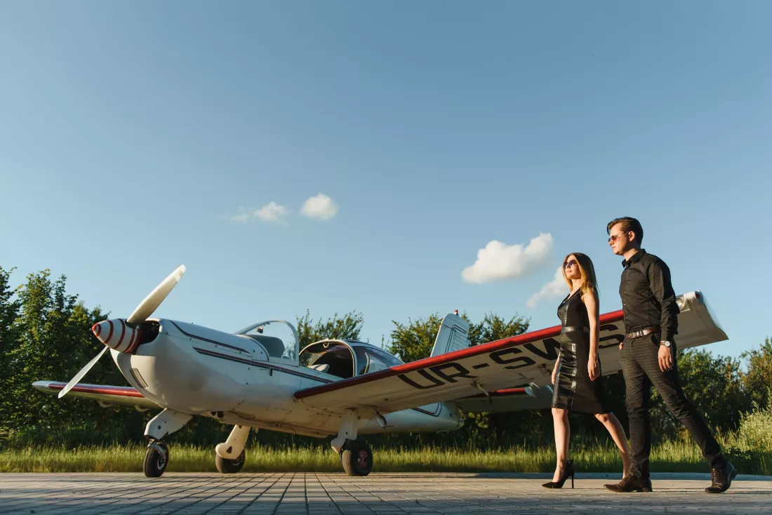 beautiful-young-stylish-couple-official-clothes-standing-near-private-plane